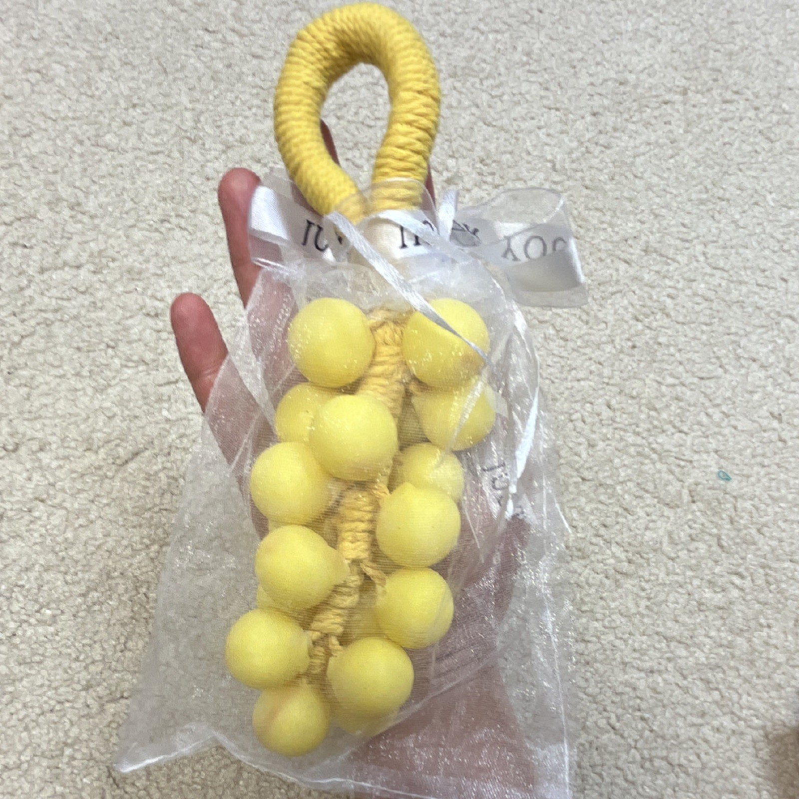 Handmade yellow grape-shaped soap.