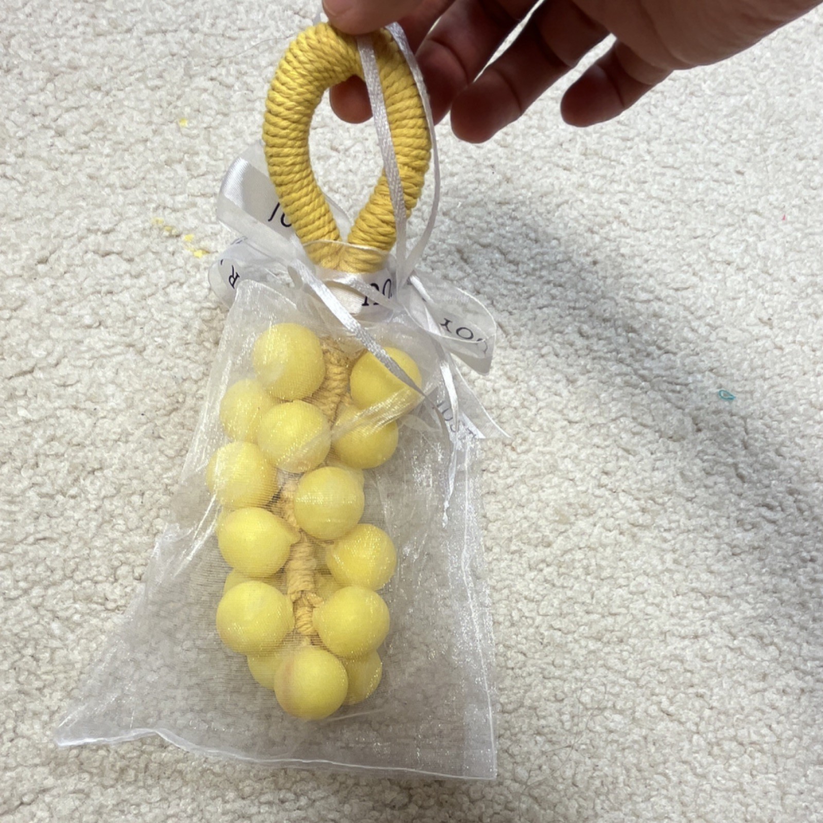 Handmade yellow grape-shaped soap.