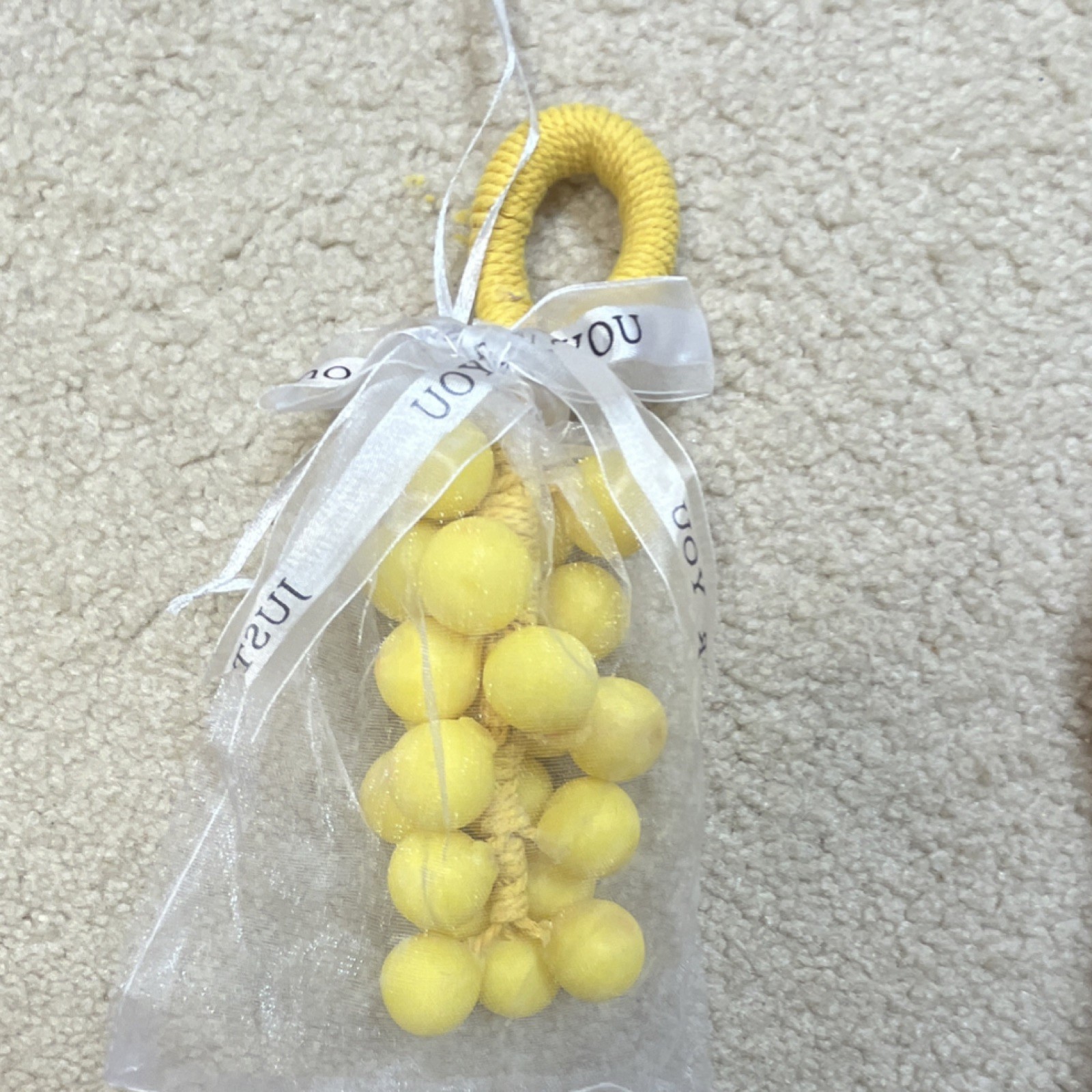 Handmade yellow grape-shaped soap.
